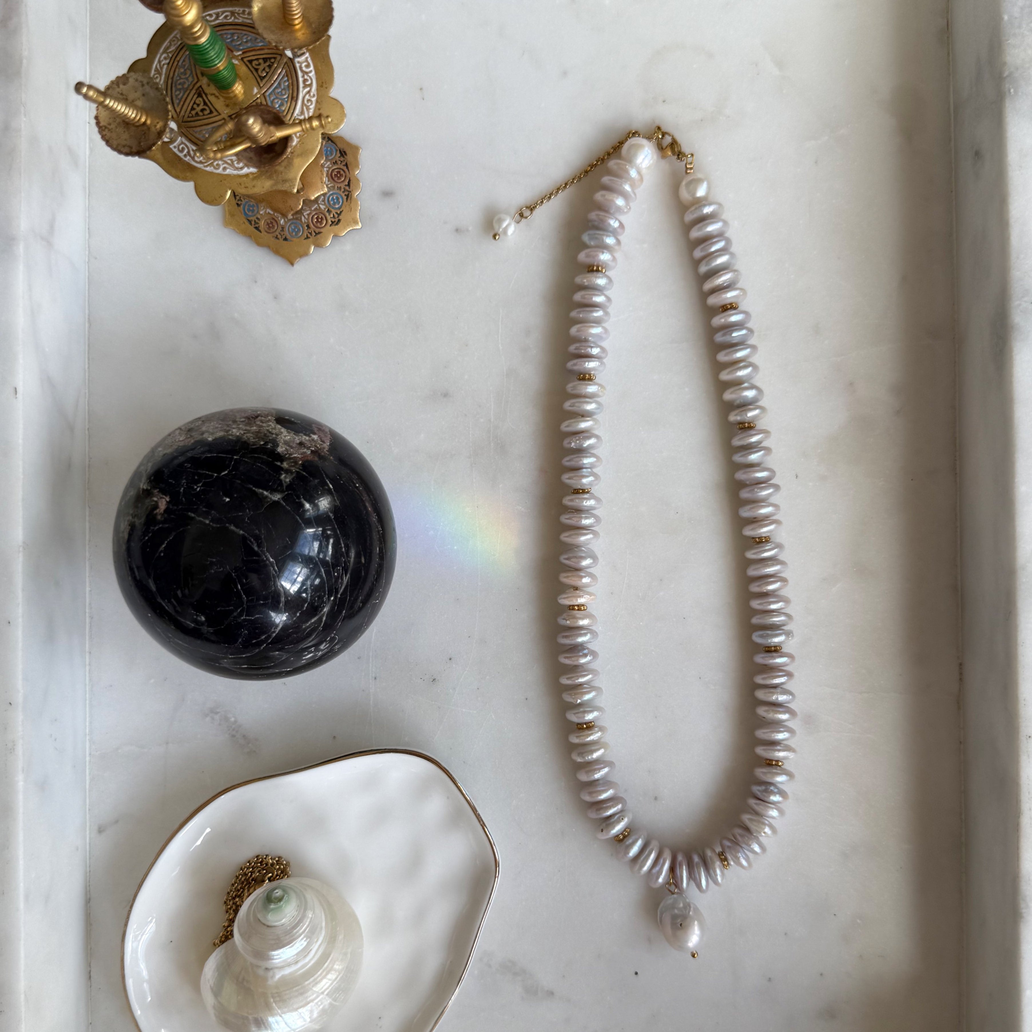 The Coco freshwater pearl necklace by Wild Alabaster — Coco Chanel–inspired design with coin pearls and baroque drop pendant.